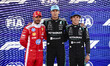 George Russell of Mercedes AMG F1 Team, Lewis Hamilton of Scuderia Ferrari, and Andrea Kim...