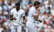 Jofra Archer of England reacts after hitting Josh Tongue of England with the ball as he pa...