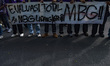 Students hold a large banner reading ''EVALUASI TOTAL MBG!! #MBG LADANG KORUPSI'' during a...