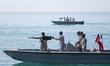 Iranian Navy soldiers are seen on armed speed boats in the Persian Gulf near the Strait of...