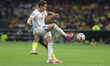 Akmal Mozgovoy #6 of Uzbekistan passes the ball during the FIFA World Cup Group K match be...