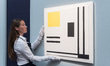 LONDON, UNITED KINGDOM - JUNE 18, 2026: An art handler poses with Marlow Moss’ "White, Yel...