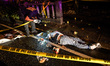 A police investigator takes pictures of the corpse of a suspected drug pusher and victim o...