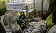 A boy sleeps next to the coffin of Ricardo Delemon, who was shot by unidentified gunmen in...