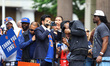 New York City Mayor Zohran Mamdani rides a float with New York Knicks players during a par...