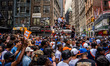 New York Knicks fans climb on a garbage truck as people gather in Lower Manhattan to celeb...