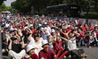 South Korean football fans cheer from a road across from the Korea Investment & Securities...
