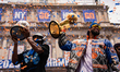 New York Knicks center Karl Anthony Towns holds the Larry O'Brien Trophy alongside teammat...