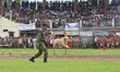 An Indian soldier from the Central Reserve Police Force (CRPF) run along with a Dog jump a...