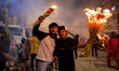 Nepali devotees light haystacks and carry straw torches as they participate in the process...