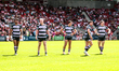 Huddersfield players watch the big screen while waiting for a referee's decision during th...