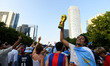 Argentine fans participate in a flag-waving event at Klyde Warren Park in Dallas, United S...
