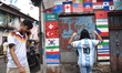 Enthusiasts wearing Argentina's No. 10 jersey with the name of Lionel Messi stand in front...
