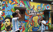 Enthusiasts wearing Argentina's No. 10 jersey with the name of Lionel Messi stand in front...
