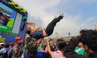 Fans of the France national team throw a woman into the air in celebration during the FIFA...