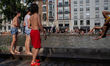 Teenagers watch a person perform a backflip into the water in Paris, France, on June 23, 2...