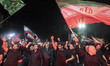 Pro-government supporters wave Iranian national flags and shout slogans during a rally in...