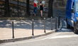Two young people carry portable electric floor fans along a street in Perugia, Umbria, Ita...