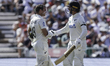 Tom Latham of New Zealand is congratulated for scoring a century during the first day of t...