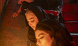 Young Iranian women light candles during a ceremony marking the anniversary of the martyrd...