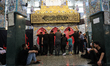 Shiite worshippers perform prayers in front of the shrine of Sayyida Zeinab in the Damascu...