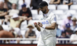 Daryl Mitchell of New Zealand inspects the ball during the third day of the Third Rothesay...