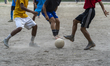 Children play football on a dusty neighborhood field in Guwahati, India, on June 27, 2026....