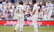 Rachin Ravindra and Daryl Mitchell of New Zealand look at the big screen following an LBW...