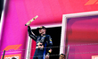 Max Verstappen, George Russell, and Kimi Antonelli celebrate on the final podium during th...