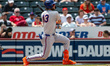 Grae Kessinger of the Syracuse Mets hits the ball during a Minor League Baseball game at C...