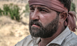 A Kurdish farmer uses a specialized traditional harvesting machine, locally known as Chaq-...