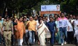 West Bengal Chief Minister Mamata Banerjee (C) walks  in a rally aimed to spread road safe...