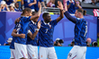 Kylian Mbappe of France celebrates with a teammate after scoring the third goal during the...