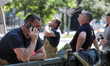 A man talks on the phone at the scene of a hotel building damaged in a missile and drone s...