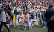 Witnesses that are about to be baptised walk past crowds at the Jehovah's Witness conventi...