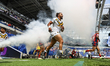 Ash Golding runs through the smoke onto the pitch during the BetFred Super League match be...