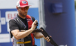 Hancock Vincent of the United States ejects shells from a shotgun during the ISSF World Cu...