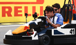 Arvid Lindblad of Racing Bulls and Esteban Ocon of Haas drive Lego karts during the driver...