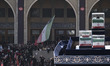 Unidentified men salute the coffins during mass funeral prayers for Iran's late Supreme Le...