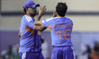 Prince Yadav of India (right) is congratulated for taking a wicket during the third Vitali...