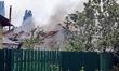 Flames burn inside a residential building damaged in Vyshneve, Kyiv region, Ukraine, on Ju...
