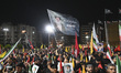 Hezbollah supporters hold photos and portraits of Iranian Supreme Leader Ali Khamenei and...