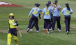 Mary Taylor of Warwickshire Bears is congratulated for taking the wicket as Ella McCaughan...