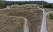An aerial view shows dry vegetation in a natural park during a period of high temperatures...