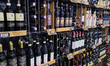 Bottles of Barolo and Vino Nobile di Montepulciano wine are displayed on a shelf at a supe...