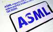 The ASML logo is displayed on a smartphone screen with the company's website page announci...