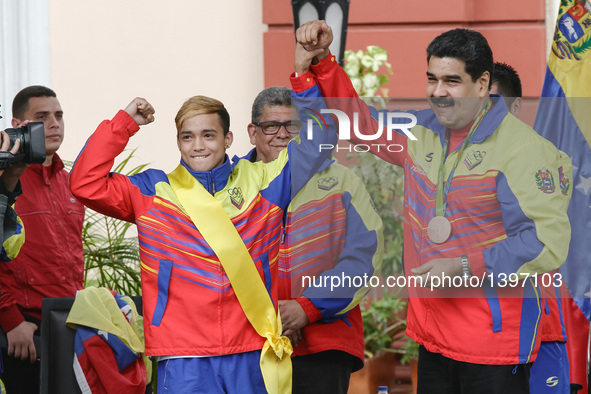 Venezuelan President Nicolas Maduro (R) and boxer Yoel Finol (2nd L) take part in the reception ceremony of the Venezuelan delegation to the...