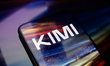The Kimi AI logo is displayed on a smartphone screen placed on a reflective surface on whi...