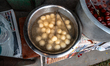 Jalebis are freshly fried on-site in large iron kadais or deep frying pans of bubbling oil...