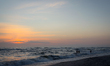 People are seen on a beach at sunset near Kleipeda, Lithuania on 19 July, 2026. 